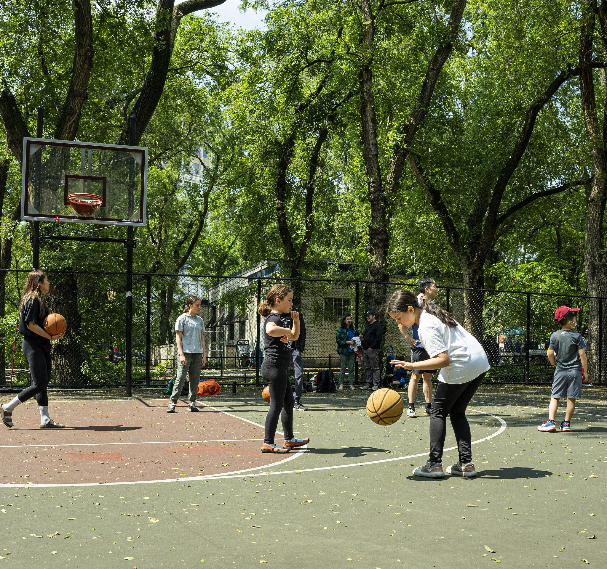 Children playing in a basketball court