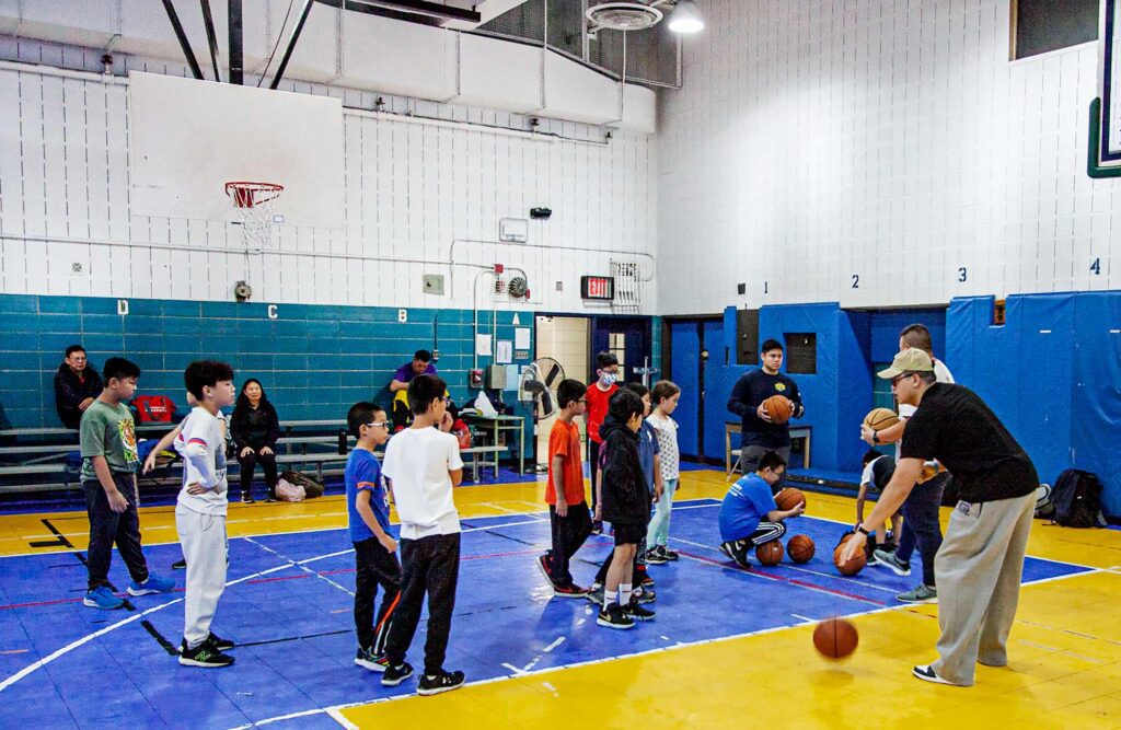A group of children learning to play basketball