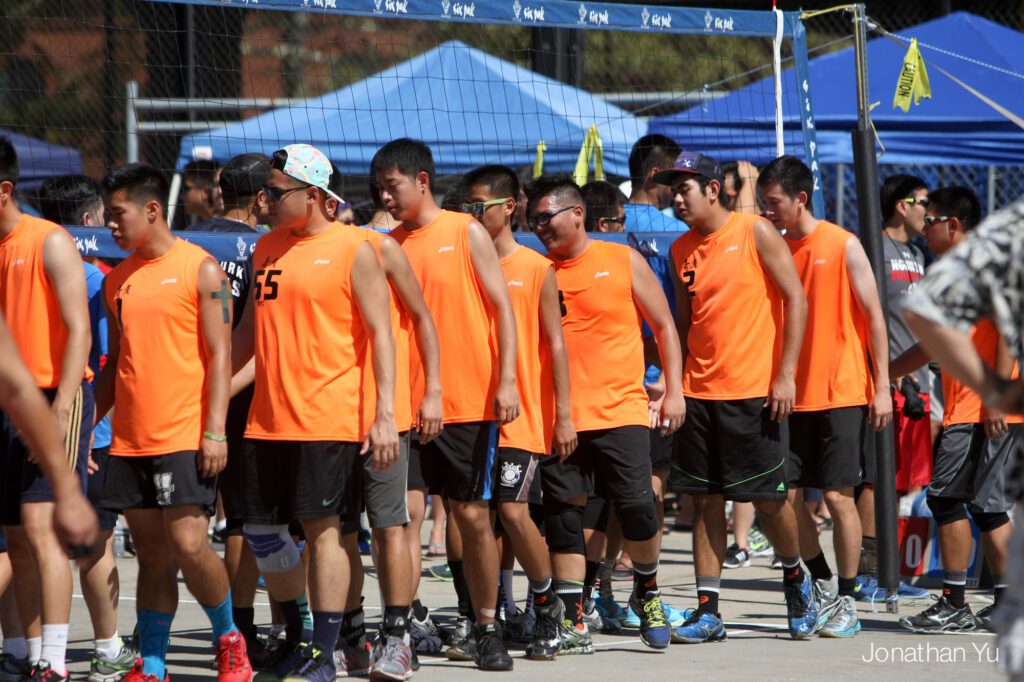 Men's volleyball teams lining up to shake hands