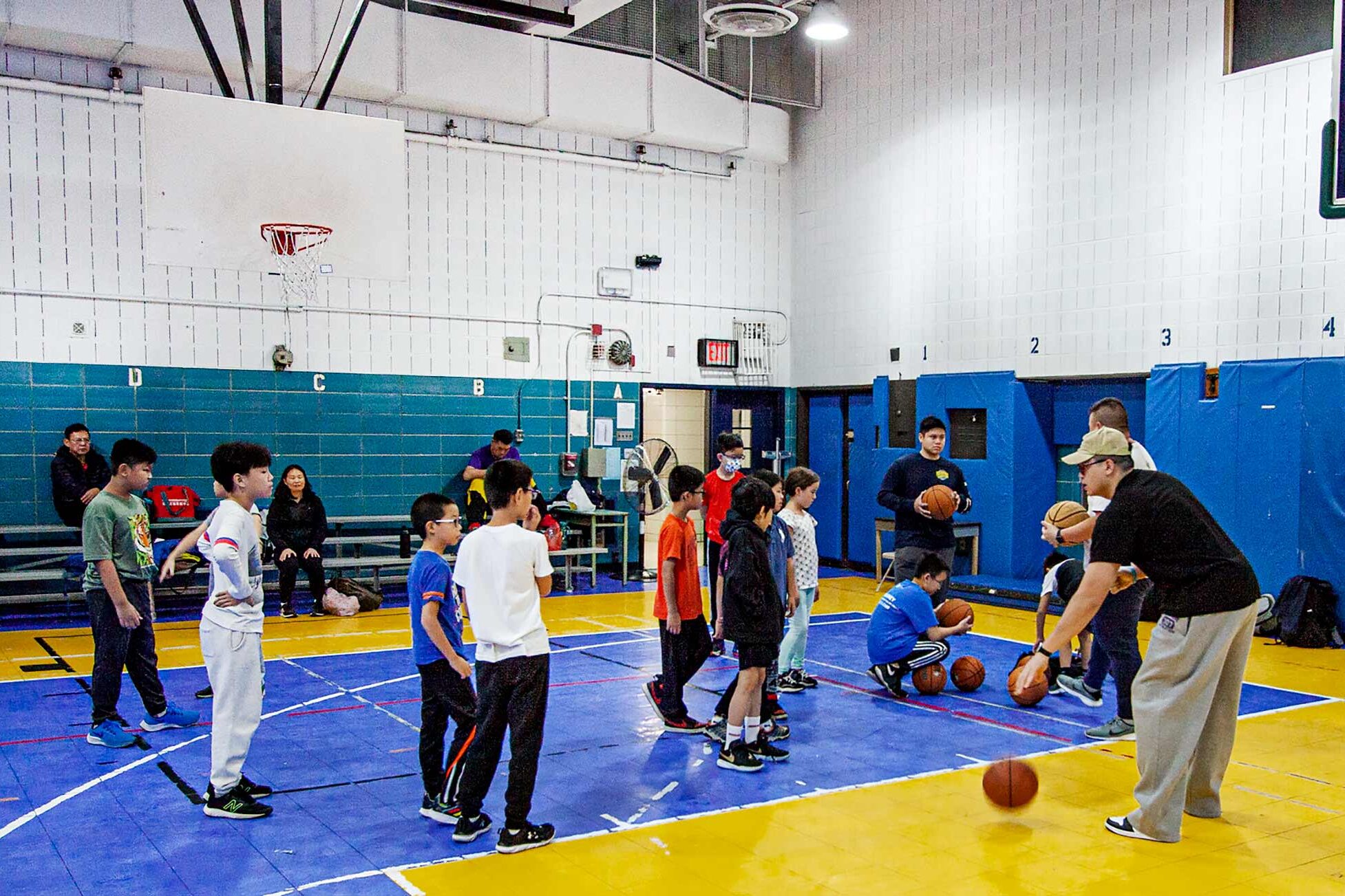 Children playing basketball in a gym